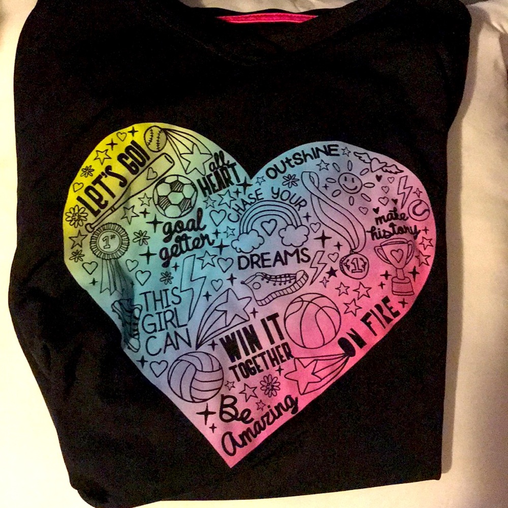 This is a athletic shirt with sports on the heart